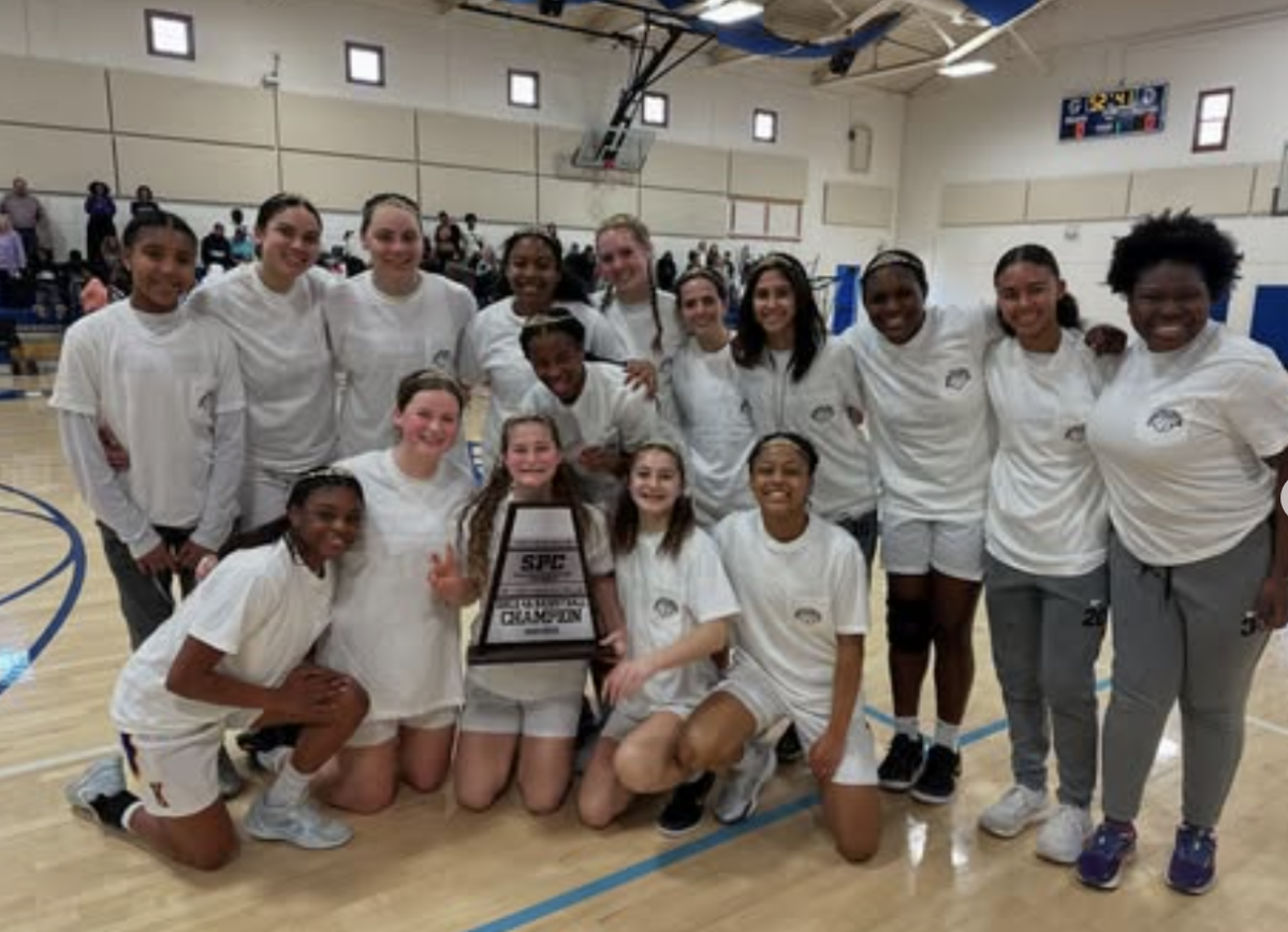 The girls basketball team poses with their SPC Championship trophy